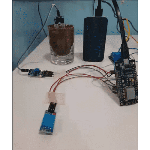 IoT sensor prototype connected to a microcontroller and plant