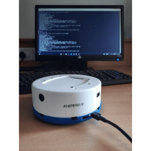 Kobuki mobile robot beside a computer running robotics software